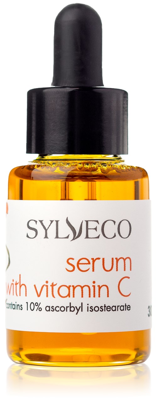 En liten oransje flaske med svart dråpetrekk med vitamin C-serum. Etiketten viser merke og produktinformasjon.