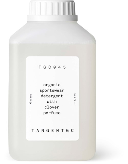 A white bottle labeled as organic sportswear detergent with clover perfume.