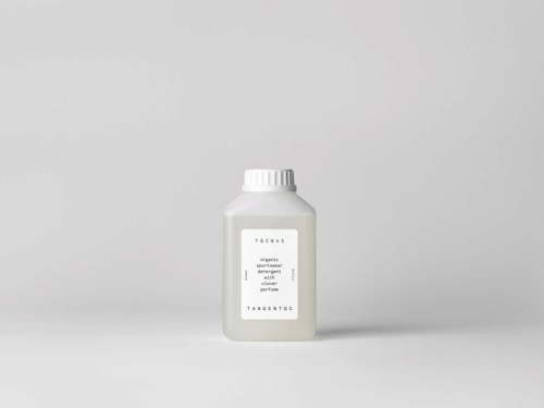 A white bottle with a simple label stands on a plain background.