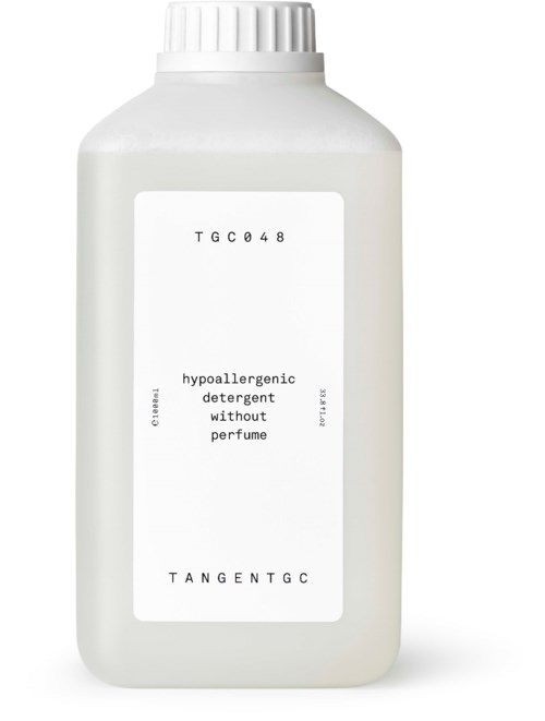 Plain white bottle with a label that says 'hypoallergenic detergent without perfume' and some codes.