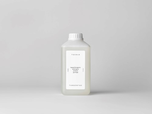 A white bottle with a cap, label reads 'TOGAS' and 'perfum'. It is plain and simple.