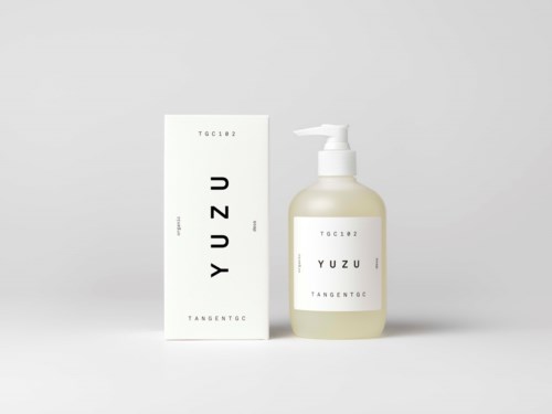 A white bottle with a pump sits beside a box, both labeled "YUZU" and minimalistic in design.