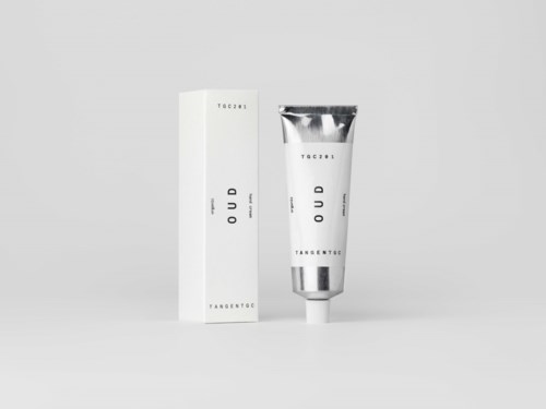 A silver tube and a white box with minimal text on a plain background.
