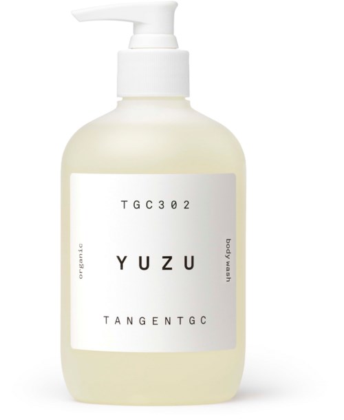A white bottle with a pump, labeled YUZU organic body wash, with simple black text and minimal design.