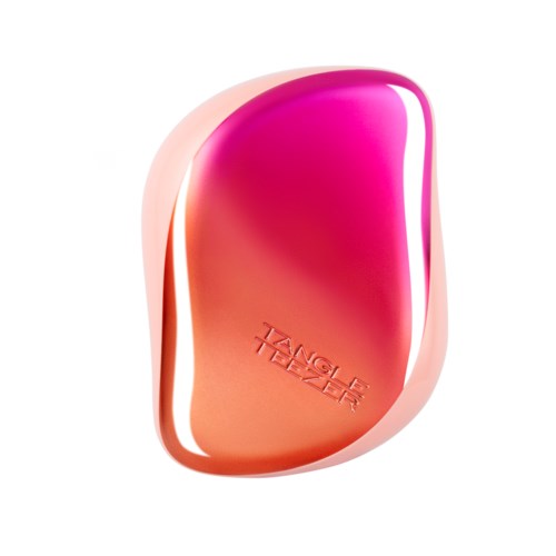 A pink and orange item with the words "TANGLE TEEZER" embossed on it. It has a curved, ergonomic shape.