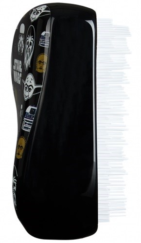 A black hairbrush with white cartoon skulls and masks, and a large amount of white bristles on one side.