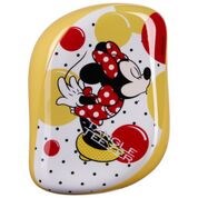 Värikäs Minnie Mouse -kuvitus, jossa on punaisia, keltaisia, mustia ja valkoisia pilkkuja ja kuvioita keltaisella taustalla.