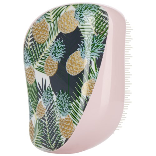 Vaaleanpunainen laite, jossa on trooppinen ananas- ja lehtikuvio etupinnalla.