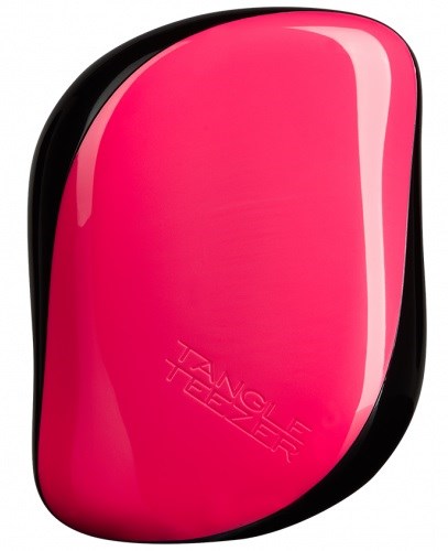 A pink and black hairbrush with the text "Tangle Teezer" embossed on it.