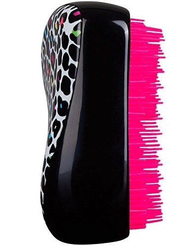 A hairbrush with a black and animal print design on one side and bright pink bristles.