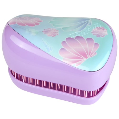 A pastel purple and blue hairbrush with shell and flower patterns on top. It has a rounded shape and a vented bottom.
