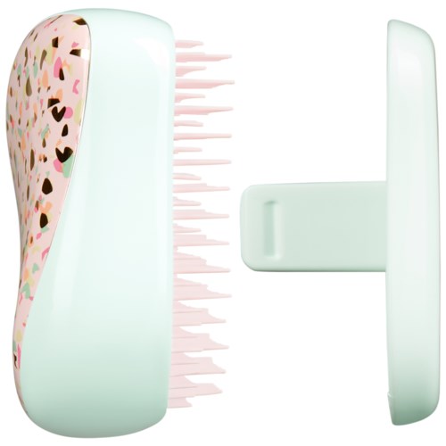 A cute brush with a colorful, polka dot design on one side and a handle, likely for cleaning or grooming.