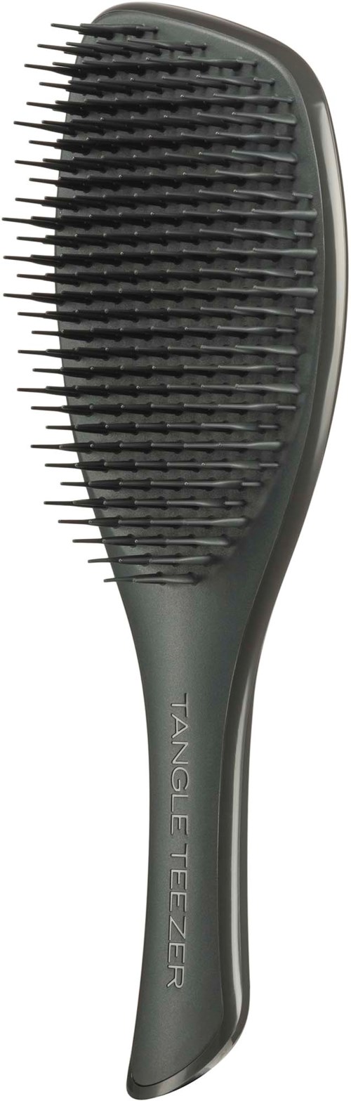 A gray hairbrush with a curved handle and wide bristle head, labeled Tang Fizzer.