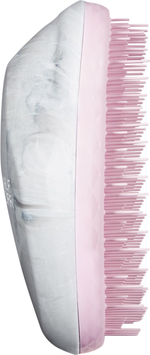 A half of a toothbrush with pink bristles and a large white shell or oyster. The background is black.