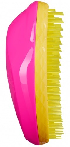 A yellow and pink cleaning brush with many sturdy bristles.