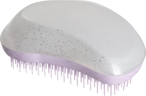 A white, oval-shaped scrub brush with purple bristles, used for cleaning skin. It has small black dots on top.