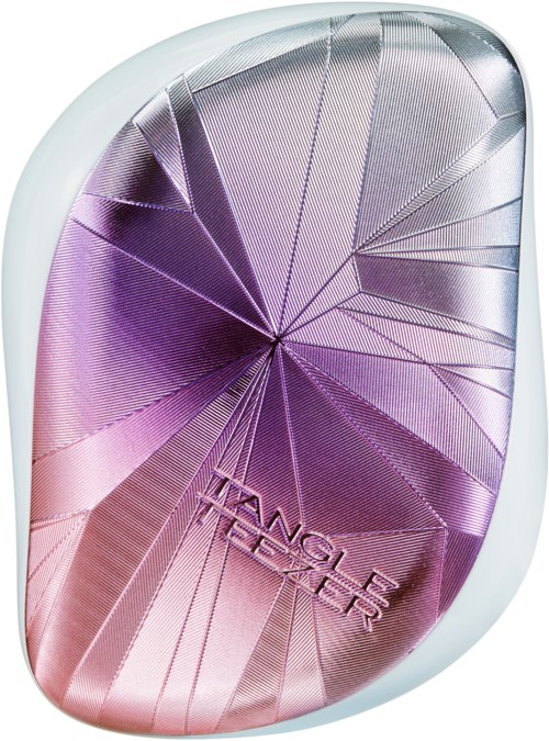Pieni, ovaalin muotoinen meikkipakkaus, jossa kiiltävä pinkki- ja violetti-kuvio, ja sanat "Angel Tears" upotettuna.