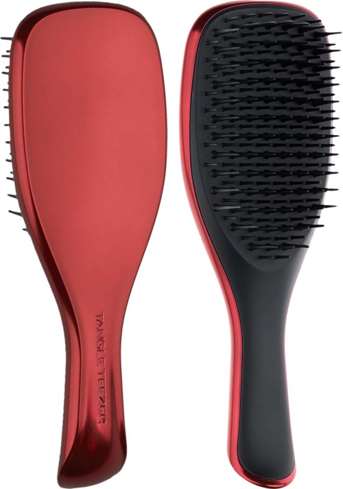 Ein Paar rote und schwarze Haarbürsten, eine glatt und die andere mit Borsten.