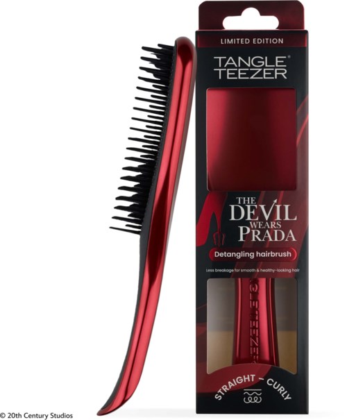 A red hairbrush with black bristles inside a box labeled Tangle Teezer, part of limited edition called The Devil Wears Prada.