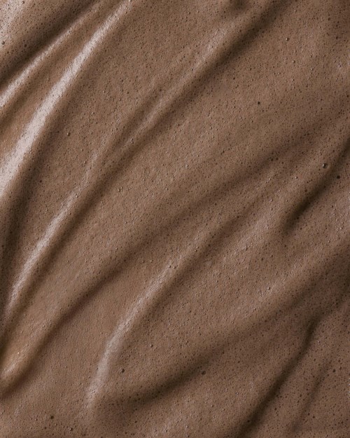 Brown fabric with wavy lines and a textured, slightly shiny surface.