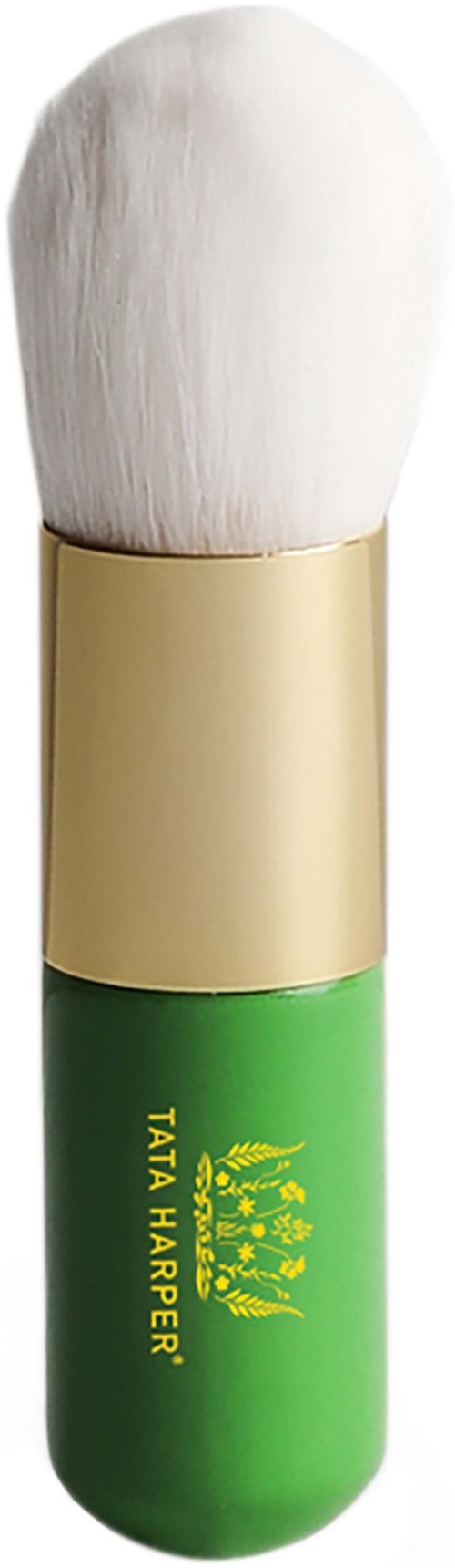 A lipstick-shaped case with a fluffy, white brush on top. Green and gold colors with text and logo. Logo says 'Tata Harper.'