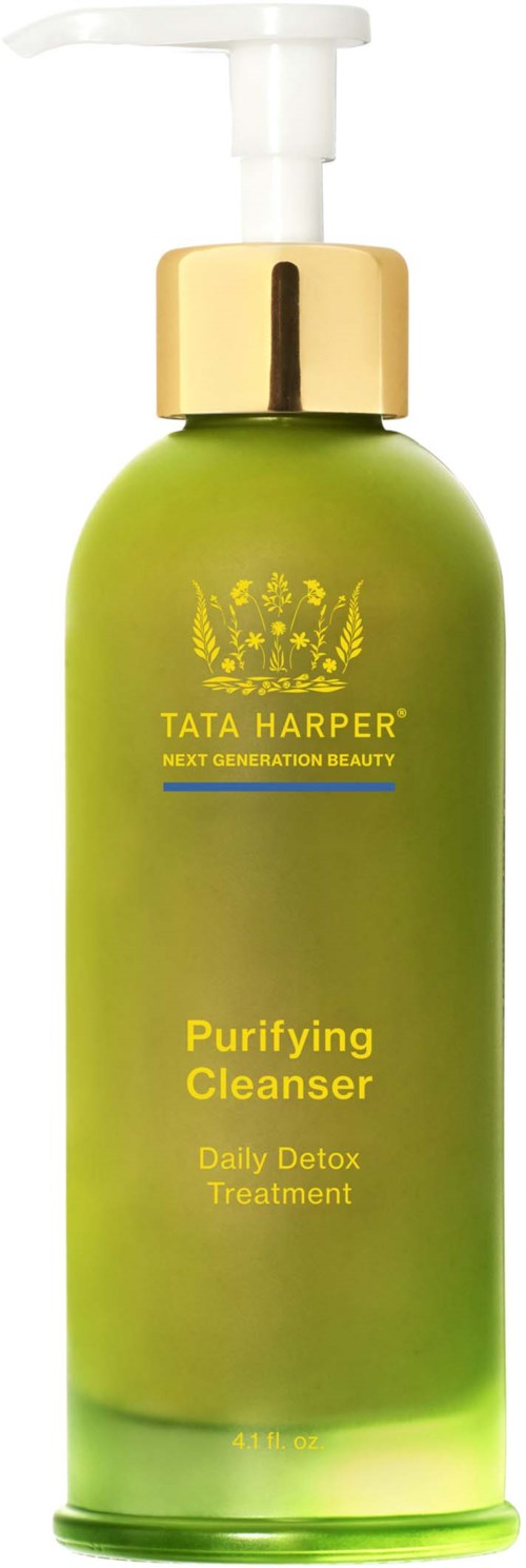 A green bottle with a pump, labeled Tata Harper Purifying Cleanser for daily detox treatment.