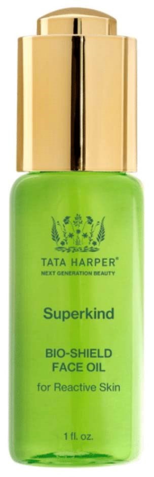 Green bottle with gold cap, labeled Tata Harper Superkind face oil for reactive skin.