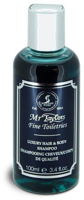 En mørk blå sjampo flaske med sølvhette, merket 'Mr Taylors Fine Toiletries' for hår og kropp.