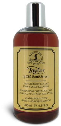 En brun flaska med Taylor sandalwood lyxigt hår- och kroppsshampoo med etikett i beige och svart lock.