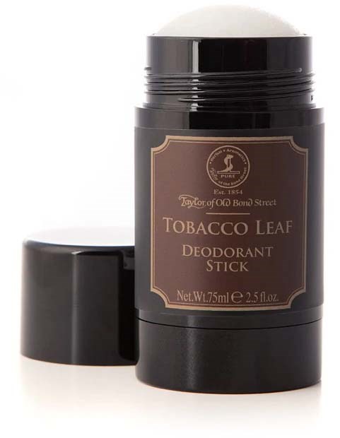 En svart deodorantstift med etikett och lock i brunt, märkt som tobaksblad doft.