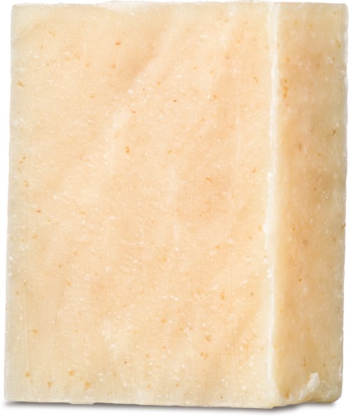 En rektangulær stykk av beige farget såpe med jevn overflate og litt avrundede kanter.
