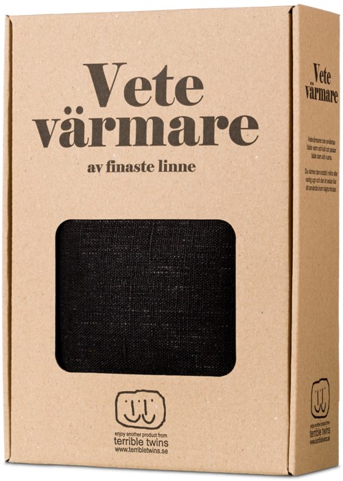 En brun papkasse med tekst om et produkt kaldet 'Vete varmer'. Den har et lille vindue, der viser et sort objekt indeni.