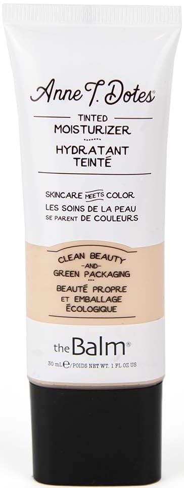 En tube med tonet fuktighetskrem med hvit og svart design, merket "Anne T. Dotes" og "the Balm."