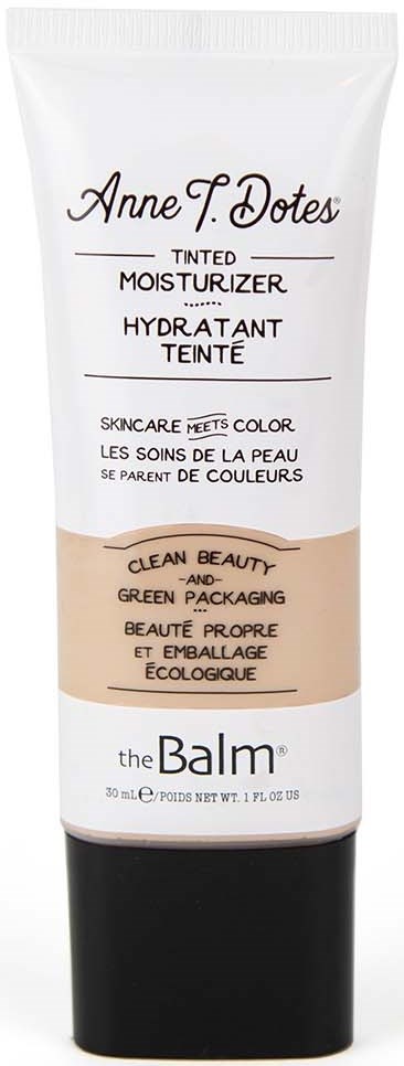 En hvid og sort tube med shimmende fugtighedscreme fra The Balm, med produktdetaljer og mærke på forsiden.