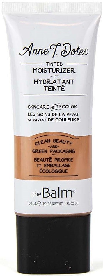 Tub med farget fuktighetskrem med svart lokk, hvit og beige etikett, og tekst som beskriver produktet.