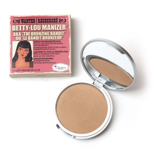 Ett bronzernyggsäck med spegel och en rosa Betty-Lou Manizer-emballage med en illustration av Betty Lou.