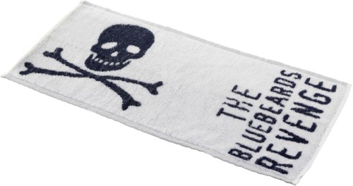 A white towel with a skull and crossbones and the words "TUE BLUEBERRIES REFUGE" on it.