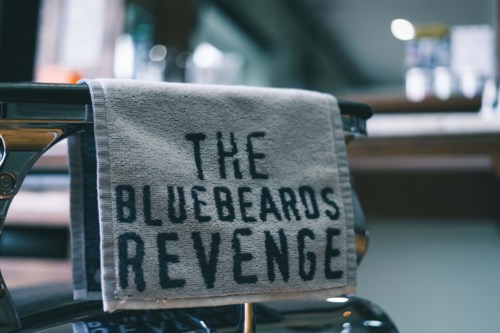 A towel with the words "The Bluebeards Revenge" hangs on a bicycle.