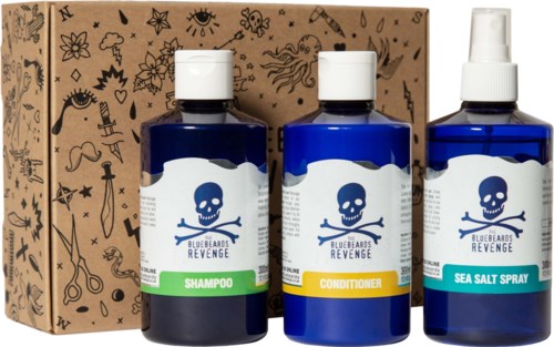 Set of three blue bottles labeled for shampoo, conditioner, and sea salt spray, with a decorated brown box behind them.