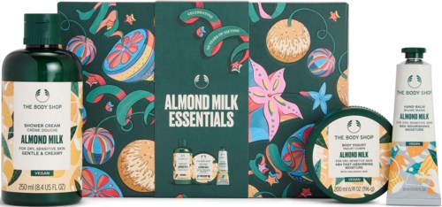 Presentset med almondmjölkskönhetsprodukter, förpackning med blommor och färgglada bilder.