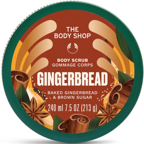 A body scrub container with gingerbread flavor, featuring images of gingerbread, cinnamon sticks, and star anise around the label.