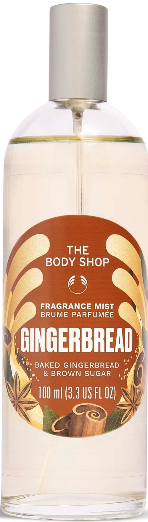 A clear spray bottle with a label for Gingerbread fragrance mist, featuring gingerbread, spices, and baked gingerbread imagery.