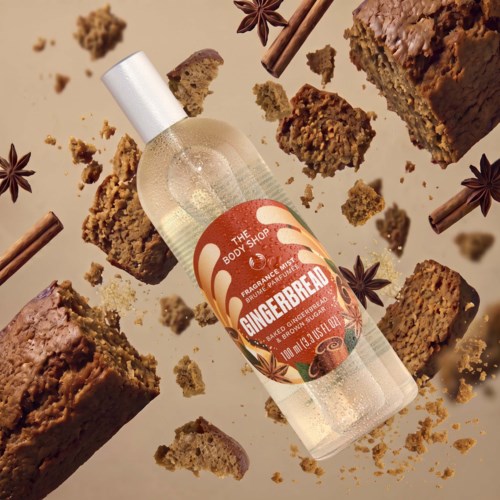 Gingerbread scented body spray from The Body Shop surrounded by cake pieces and star anise.
