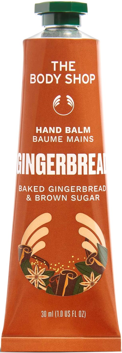 Handcremetube mit Lebkuchen- und Gewürzdesign, gekennzeichnet als The Body Shop Gingerbread Hand Balm, 30 ml.