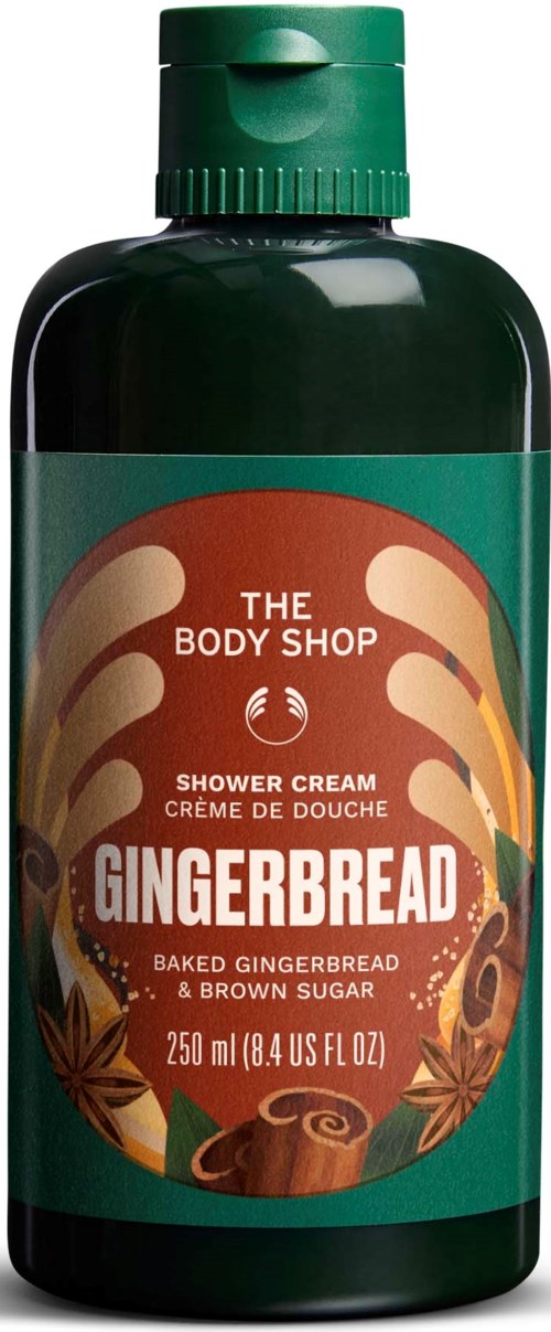 Grønn flaske med gingerbread duftende shower cream med etikett som viser bakt gingerbread og brunt sukker.