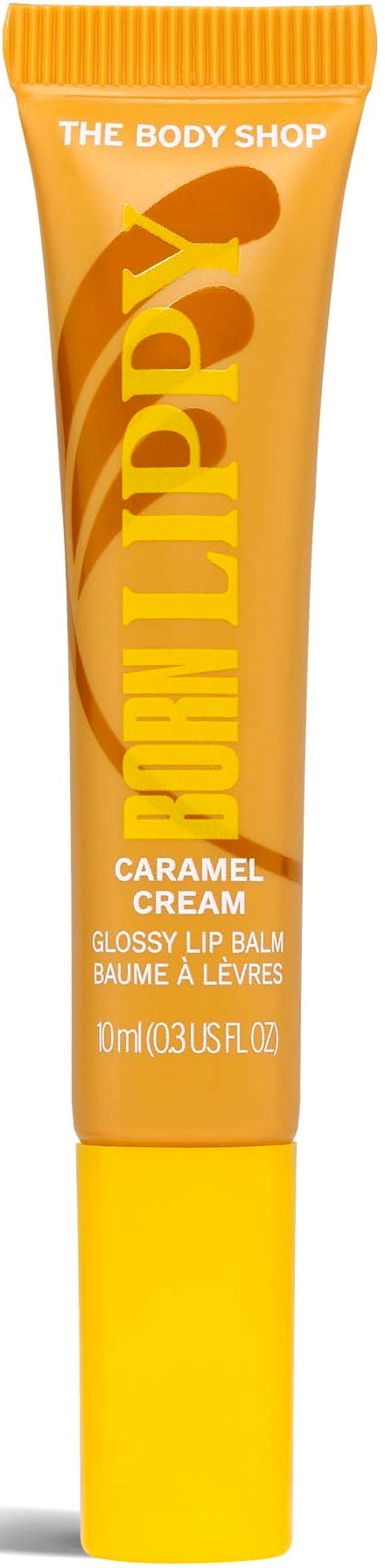 En tub av karamellsmakande glansig läppbalsam från The Body Shop i gula och orange färger.