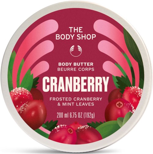 En rund locketikett för The Body Shop kranberrydoftande kroppsolja med bilder av lingon och gröna blad.
