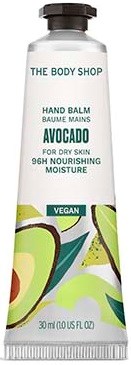 En tub handbalsam märkt 'Avocado' från The Body Shop, vegansk, för närande hud, med grönt och avokadobilder.