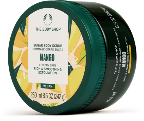 En burk med Mango socker kroppsscrub med citronbilder, vegansk märkning och varumärkesnamnet The Body Shop.