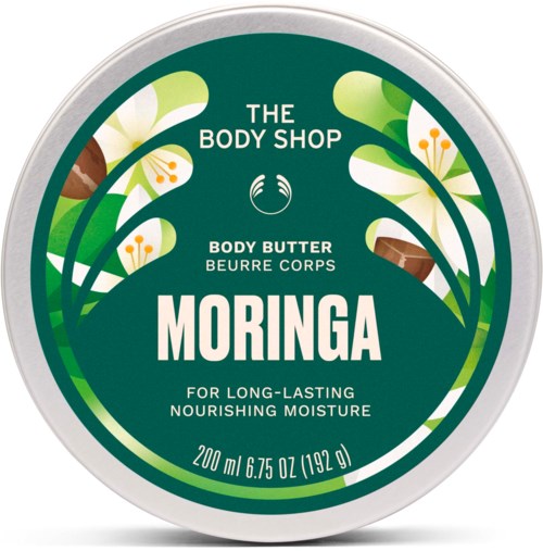En rund lokk med grønne og hvite blomsterdesign, viser The Body Shop Moringa kroppsbutter etikett.